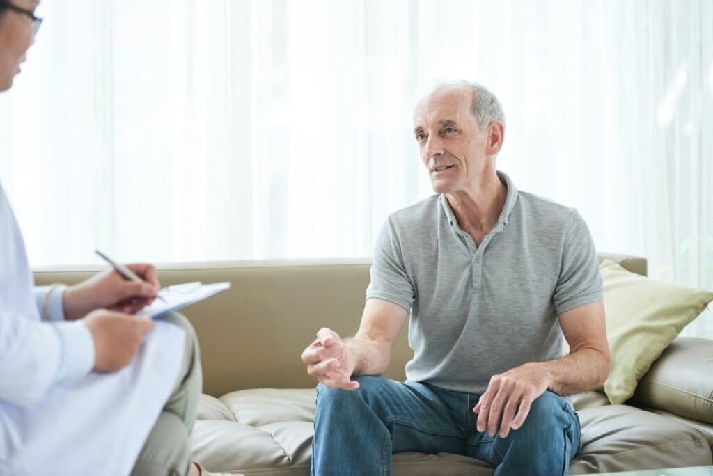 Senior man sharing problems with doctor